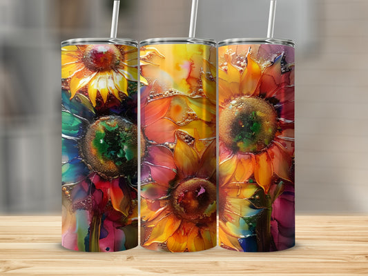 Three tumblers with colorful, abstract sunflower designs on a wooden surface.