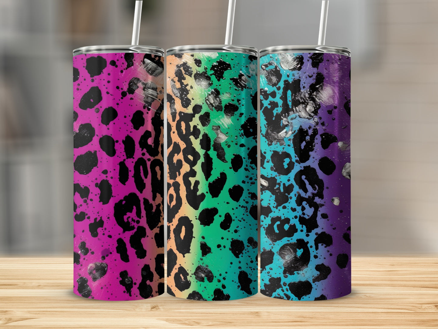 Three leopard print tumblers with colorful ombre backgrounds.