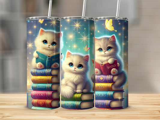 Three kittens sitting on stacks of colorful books, with butterflies and stars.