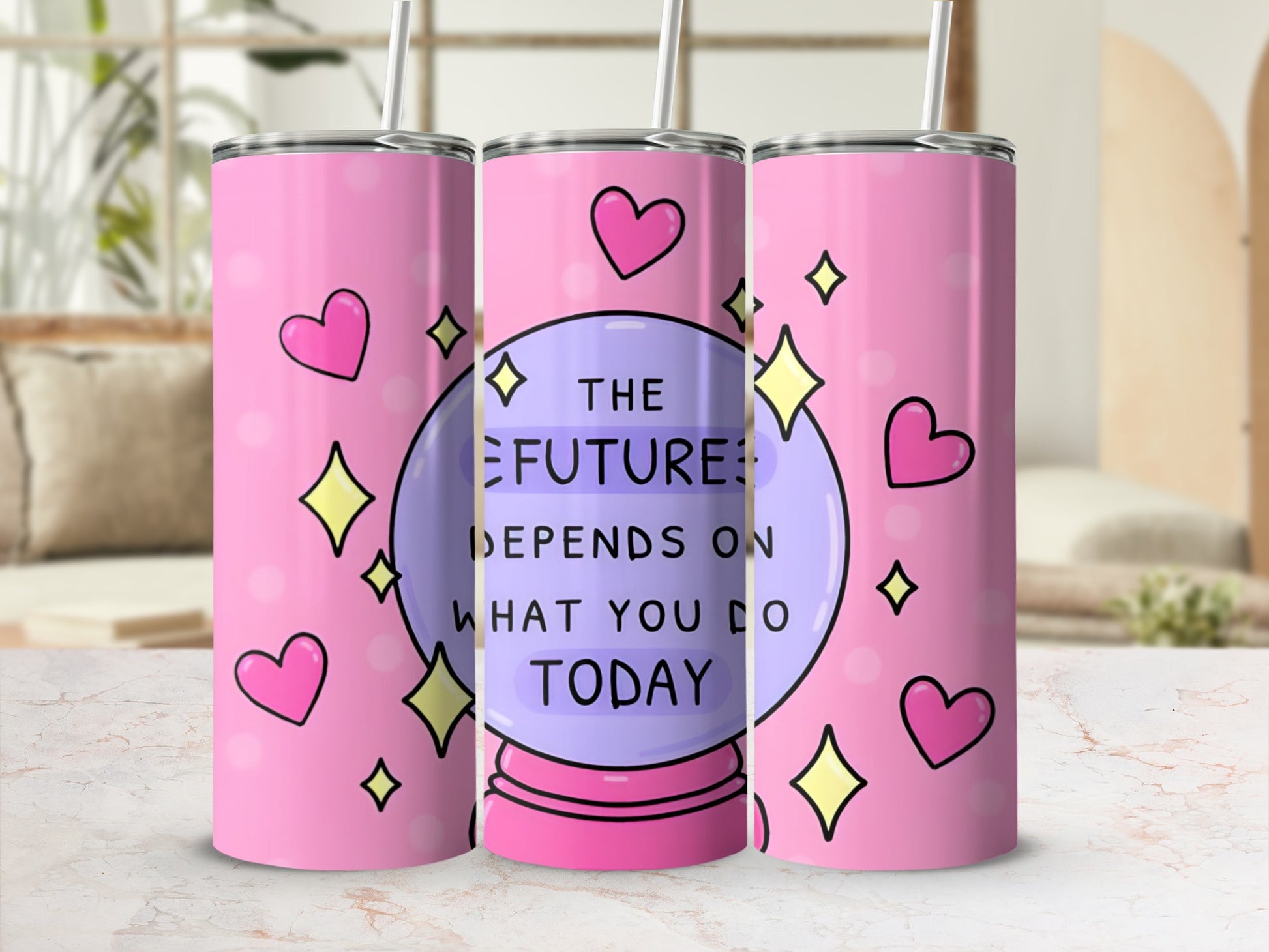 Pink tumbler with crystal ball, hearts, and stars, reading "The future depends on what you do today."