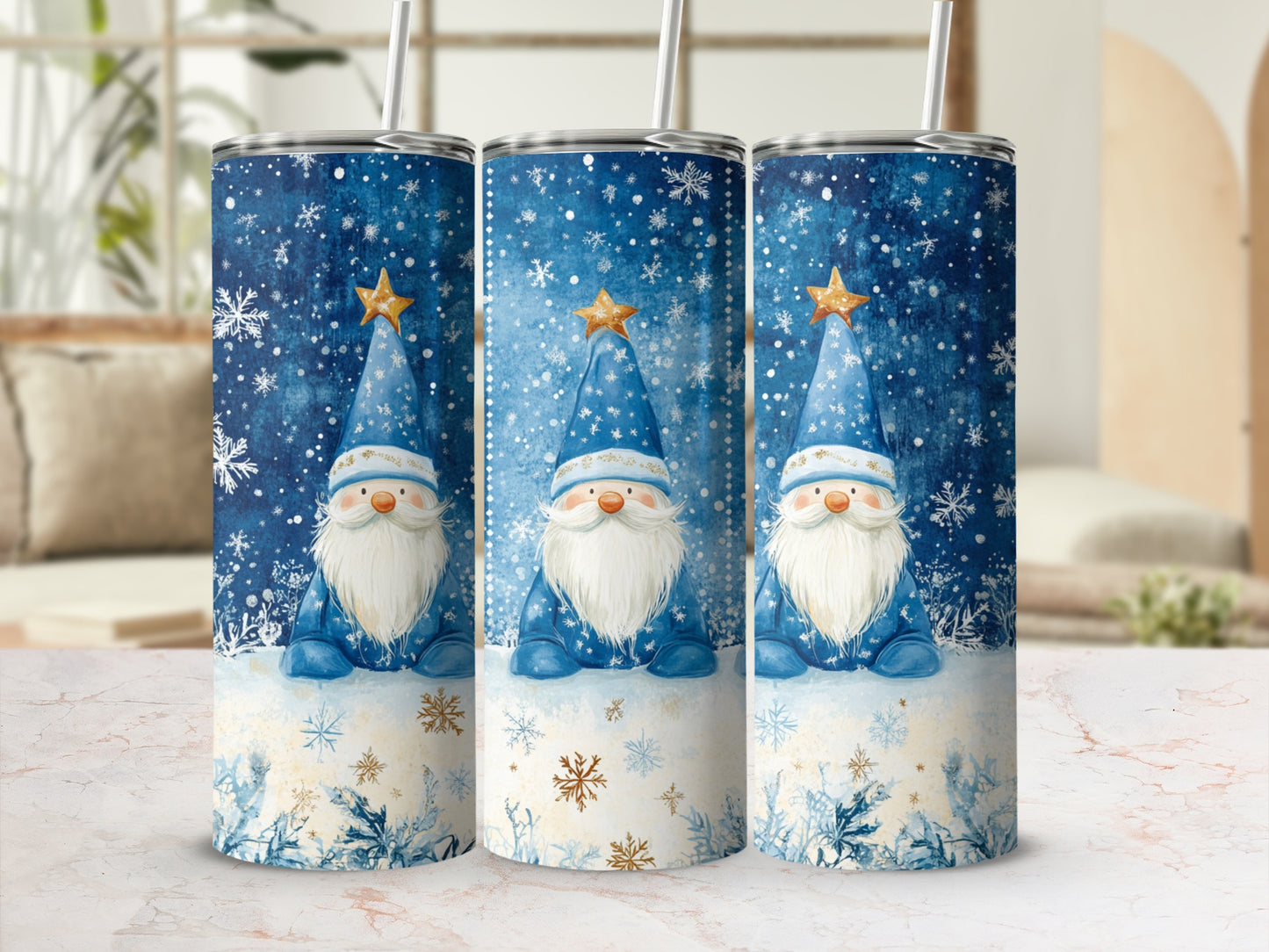 Three tumblers with a blue snowflake gnome design and gold stars.