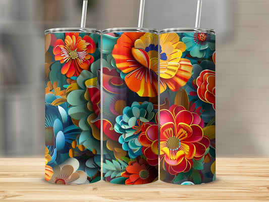 Three tall tumblers with vibrant floral patterns on a wooden surface.