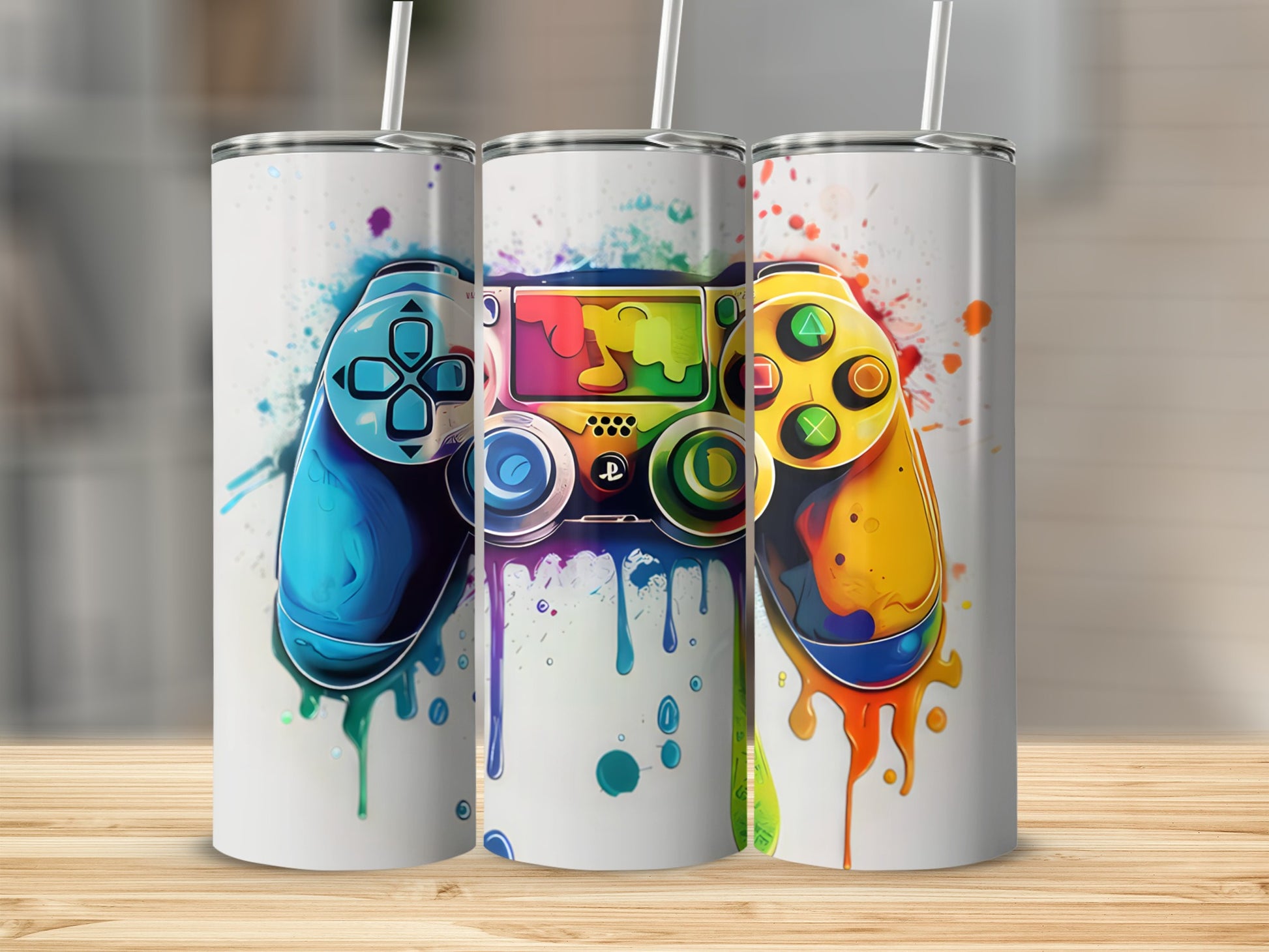 Three tumblers featuring colorful, dripping video game controllers.
