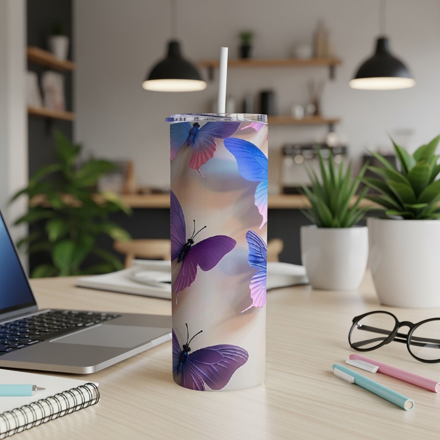 Tall tumbler with purple and blue butterflies on a blurred background.