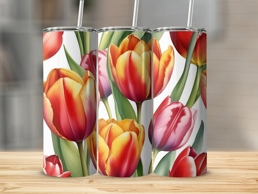 Three tumblers with a red and yellow tulip floral pattern on a wooden surface.