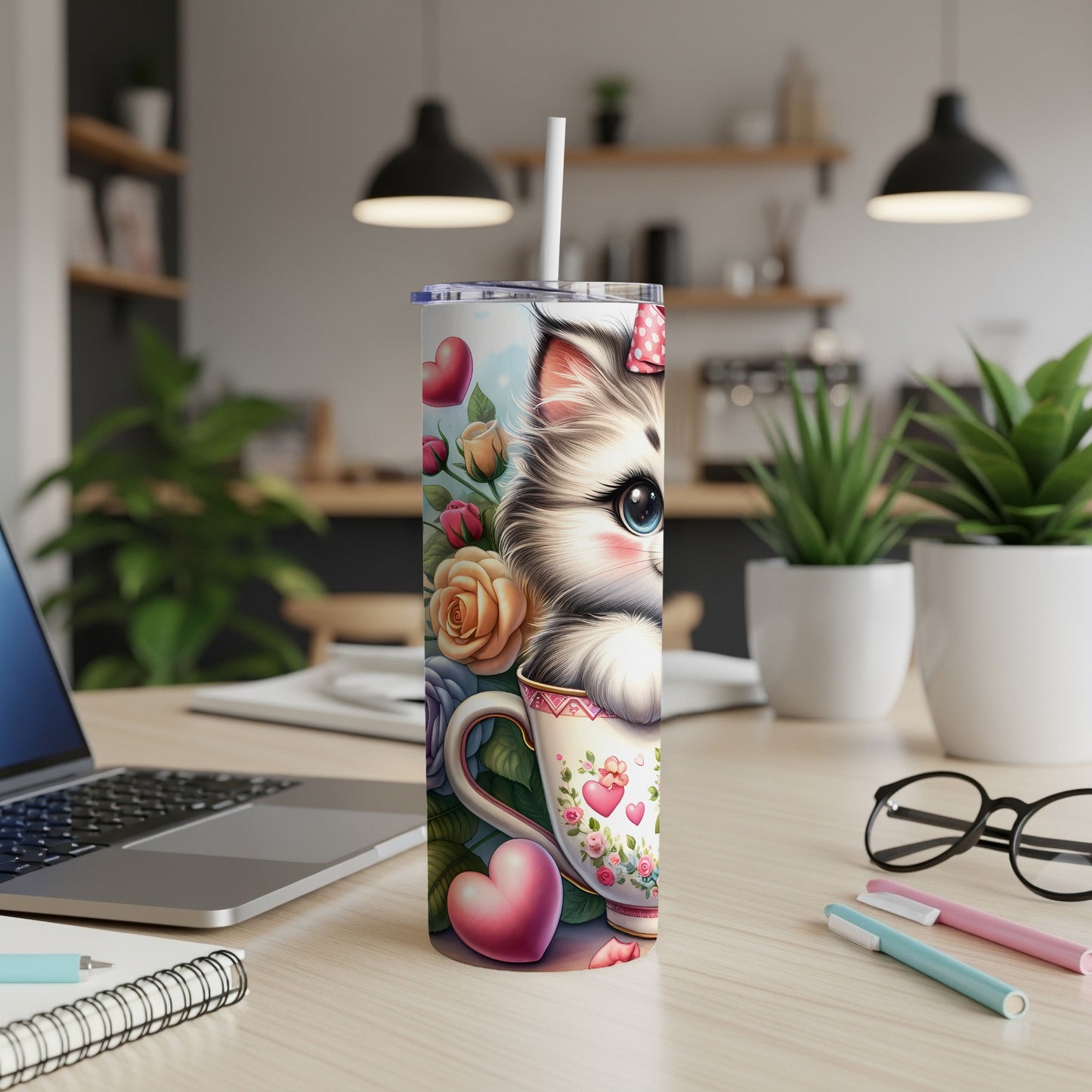 Cute cat face on a floral mug with hearts, on a wooden desk.