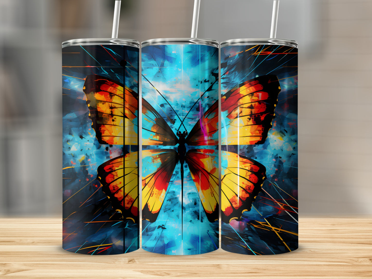 Three stainless steel tumblers featuring a vibrant butterfly design.