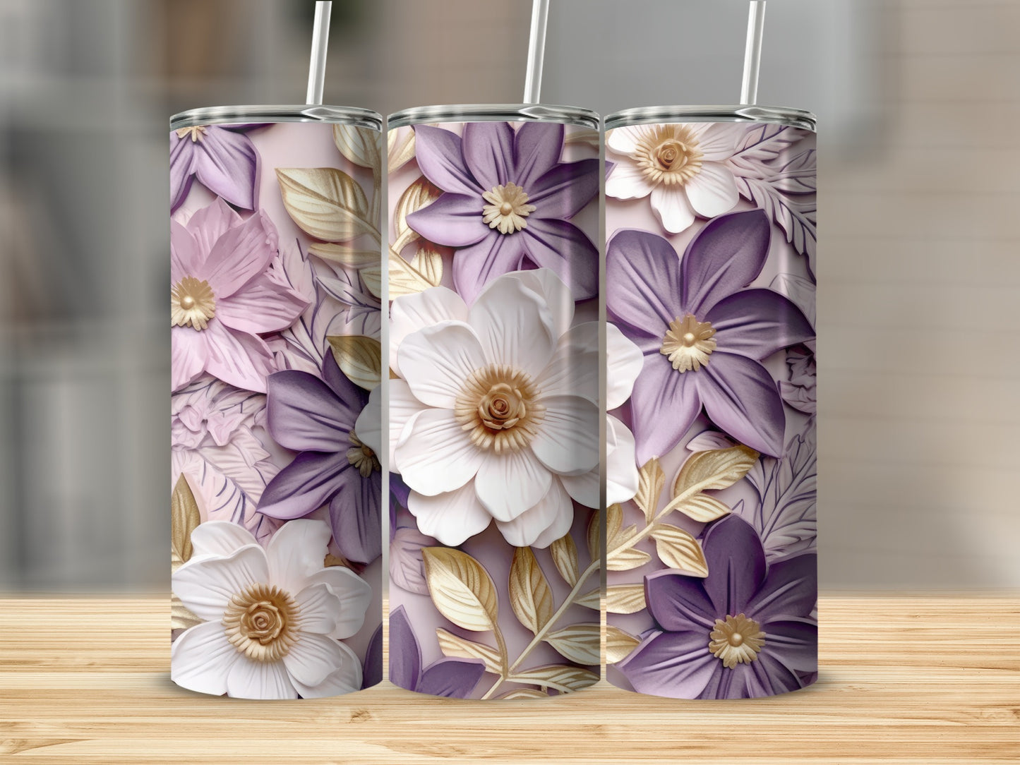Three tumblers with floral designs and gold leaf accents.