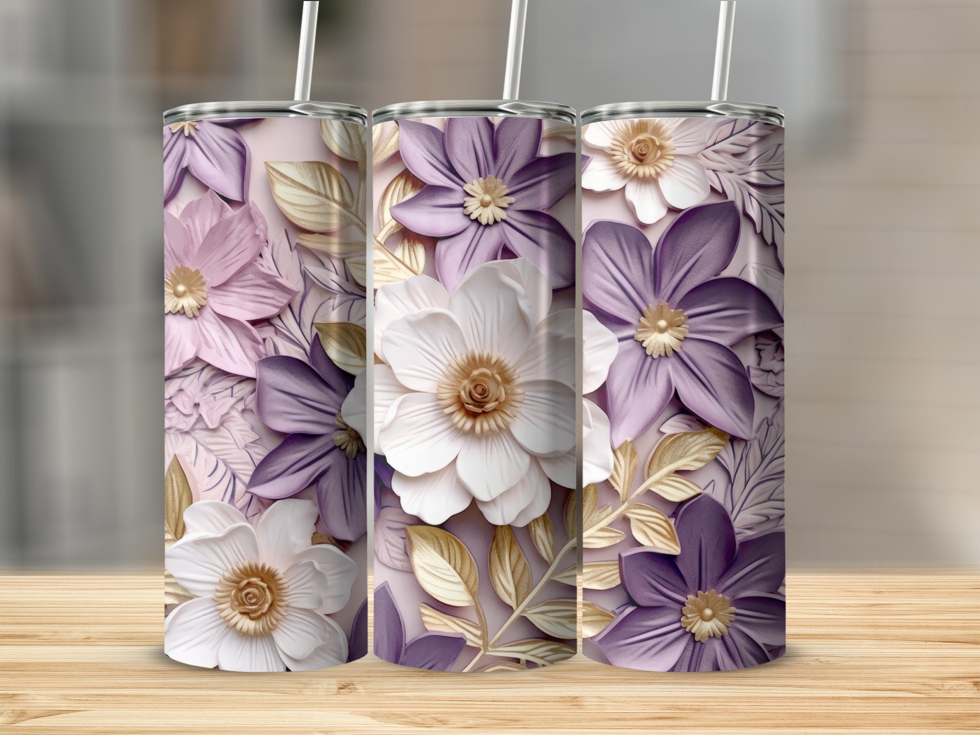 Three tumblers with floral designs and gold leaf accents.