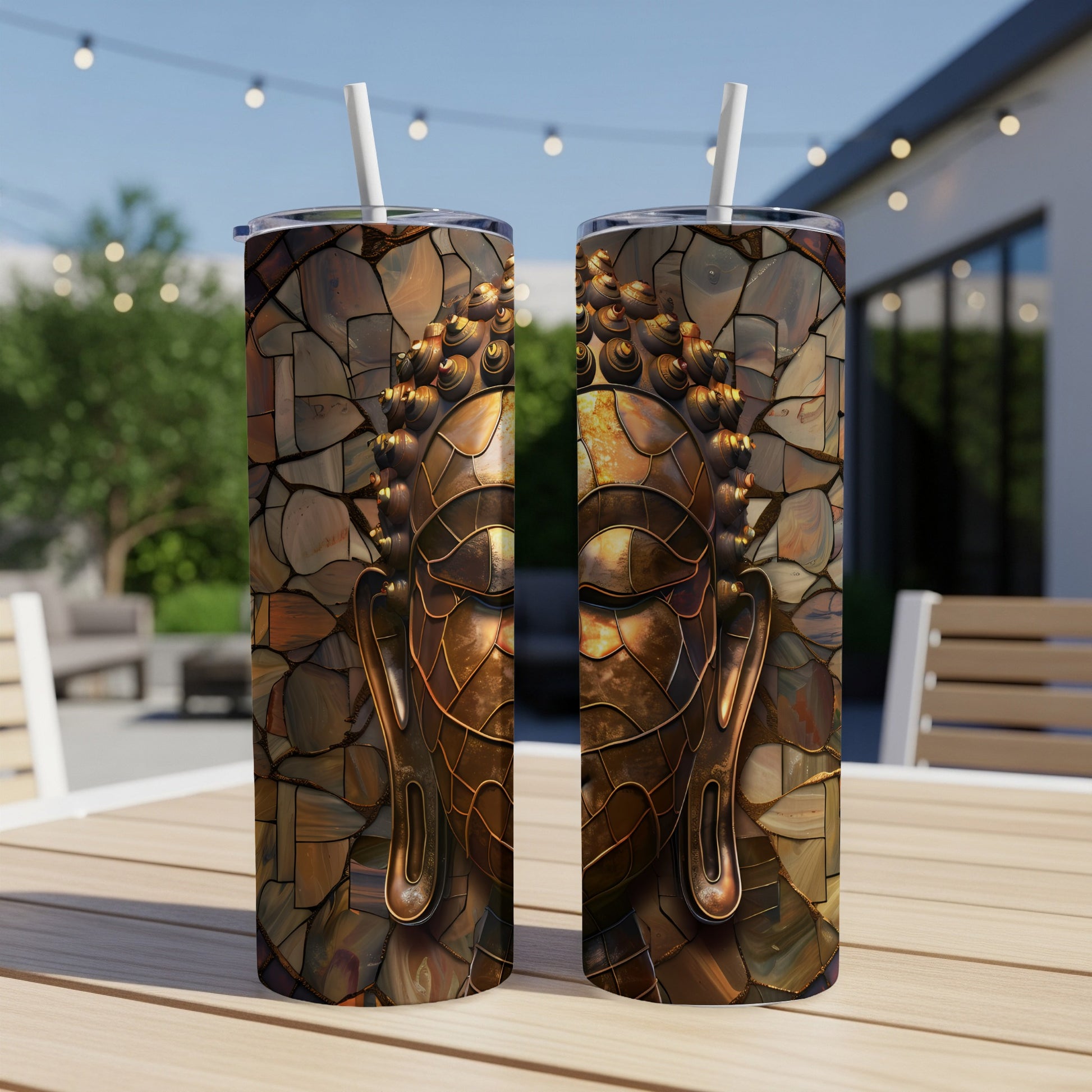 Two tall, skinny tumblers with a mosaic Buddha face design.