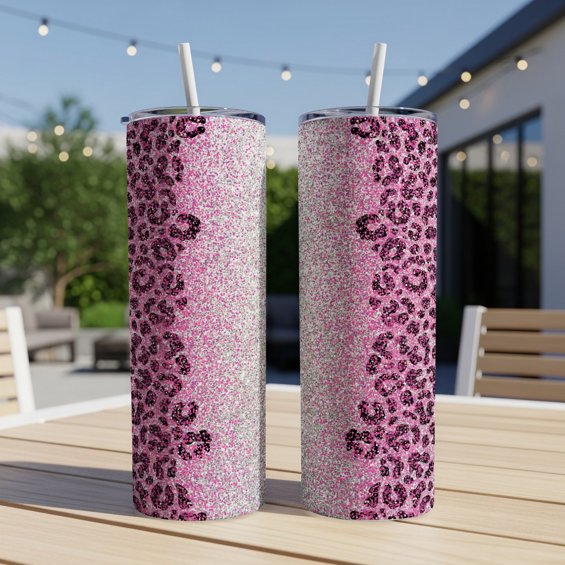 Two pink glitter tumblers with black leopard print detail, with straws.