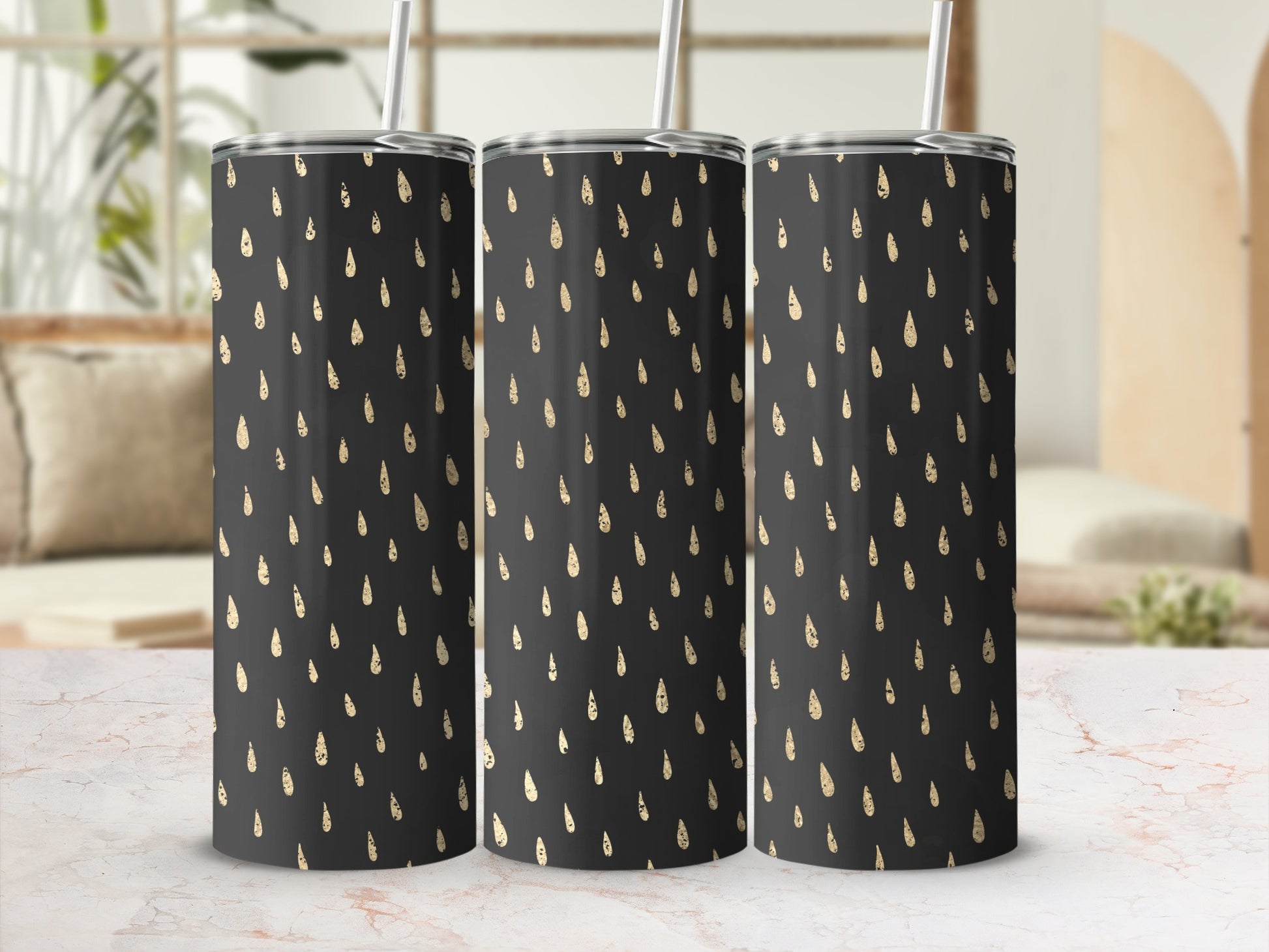 Three tumblers with a black background and a gold raindrop pattern.