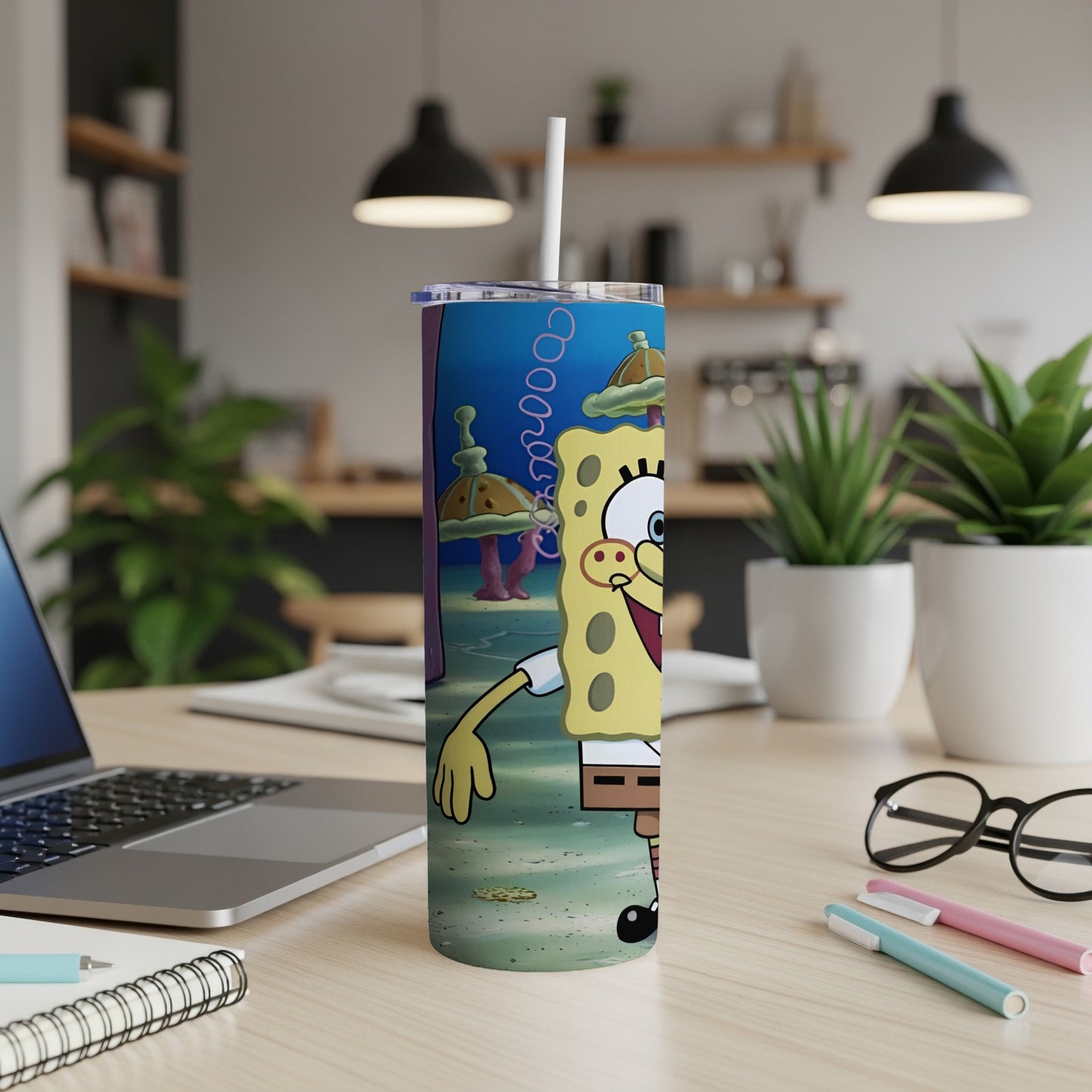 SpongeBob SquarePants character on a blue and green patterned tumbler with a straw.