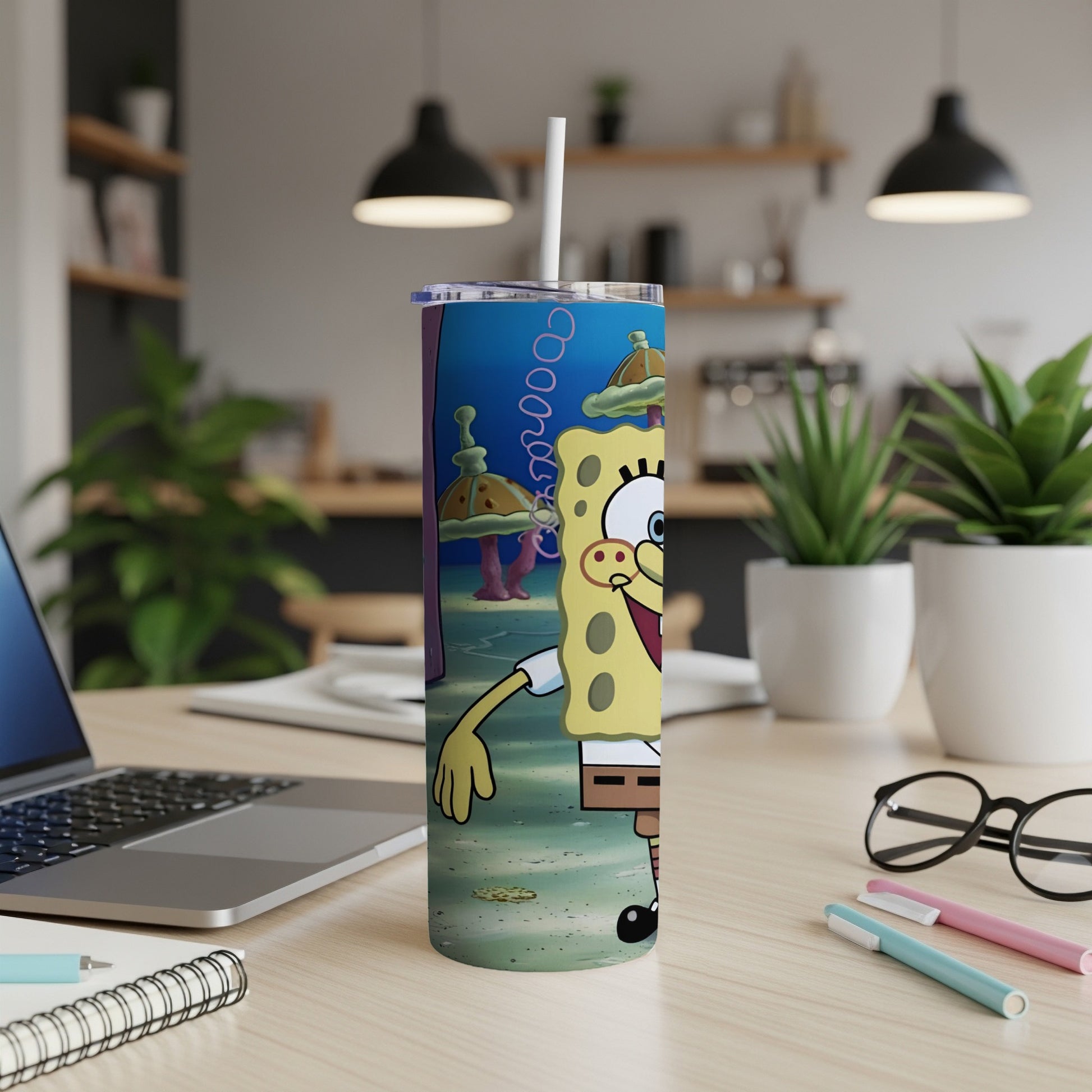 SpongeBob SquarePants character on a blue and green patterned tumbler with a straw.