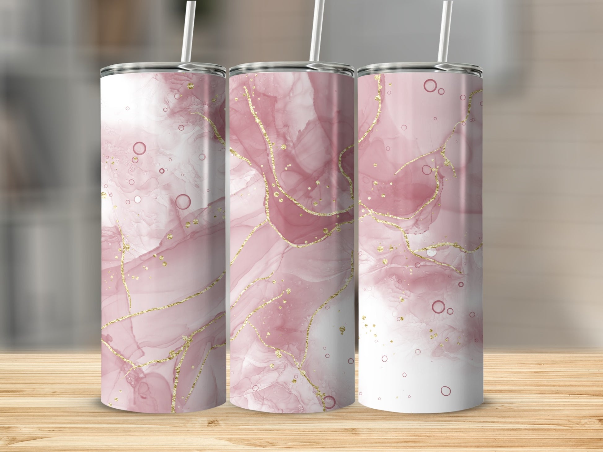Three tall tumblers with pink marble and gold accents.