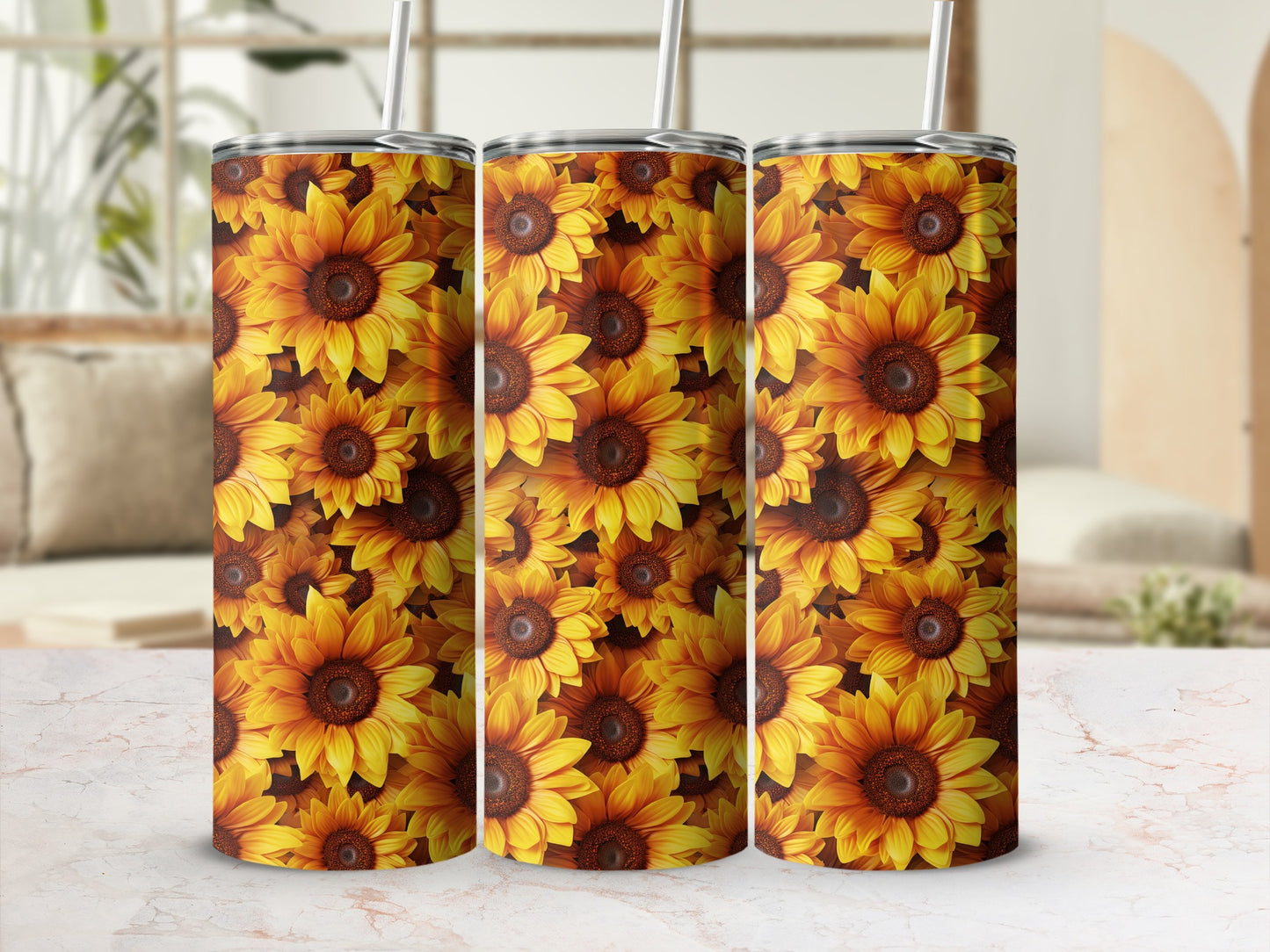 Three stainless steel tumblers with a repeating sunflower pattern.