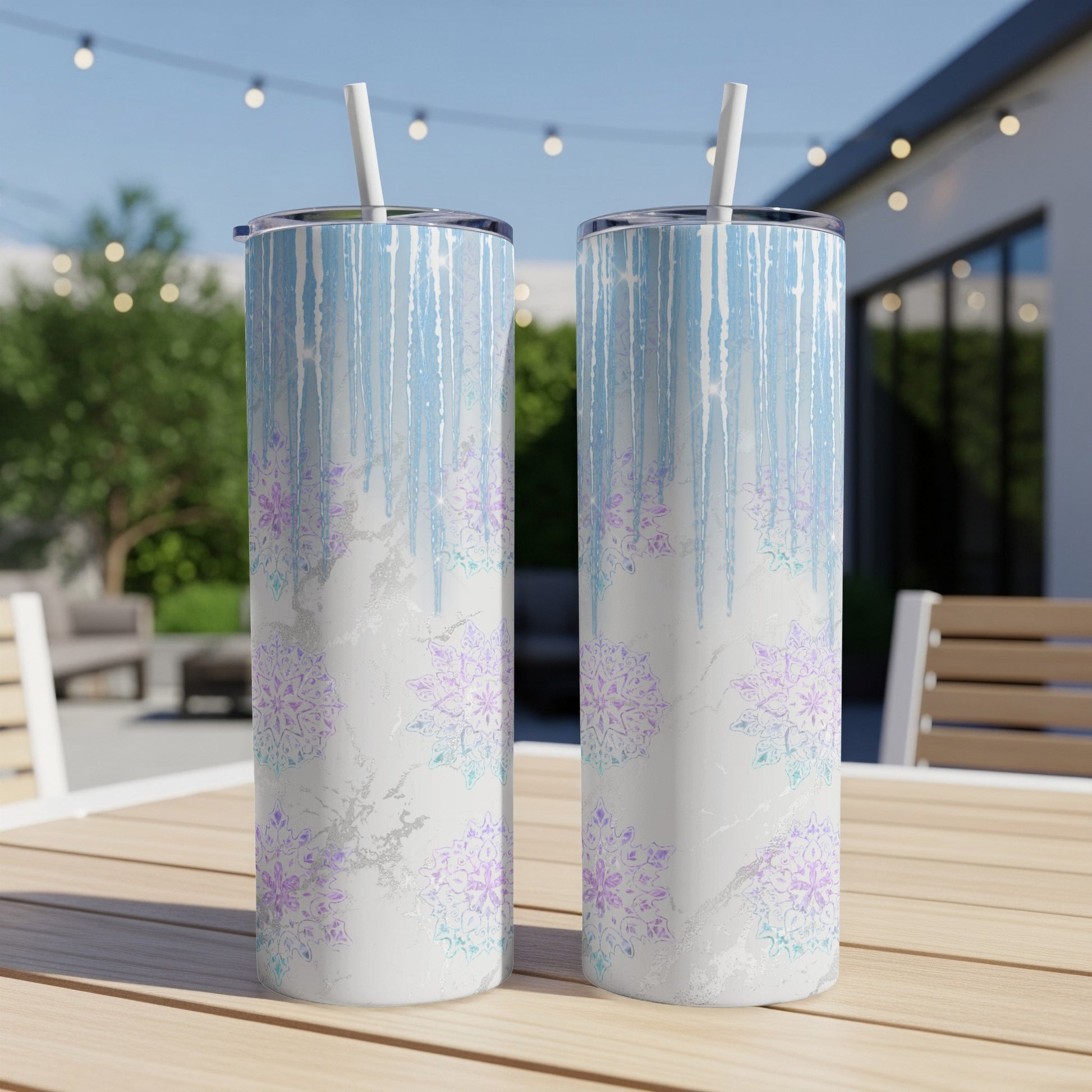 Two tall, skinny tumblers with a blue, white, and purple snowflake pattern.