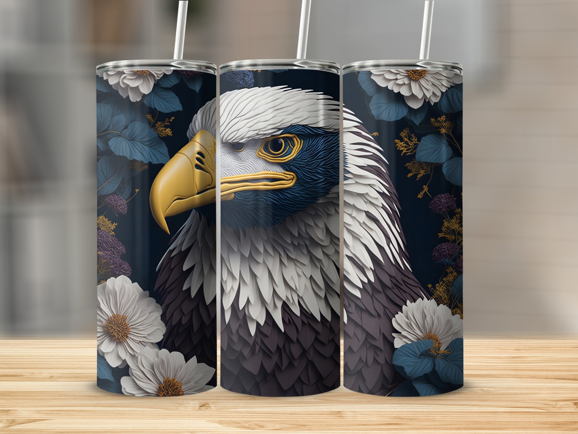 Eagle head design on a set of three tumblers with floral accents.