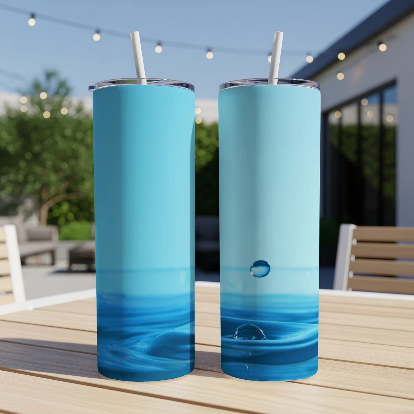 Two blue tumblers with water ripple design on a wooden table.