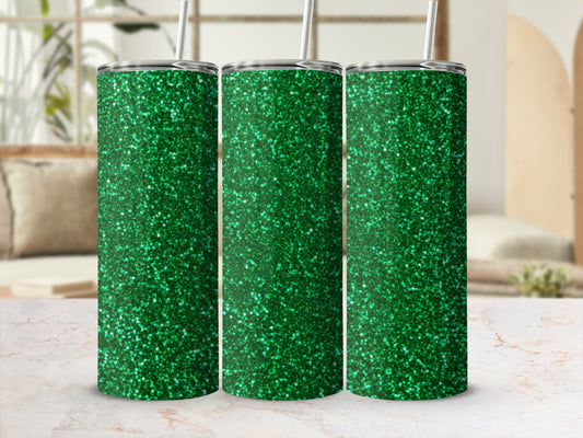 Three green glitter tumblers with straws in a studio setting.