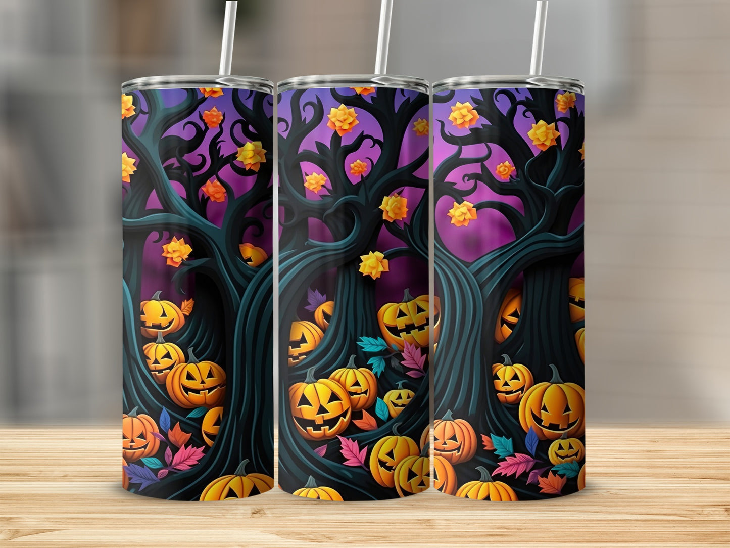 Three tumblers with a Halloween design of jack-o'-lanterns and spooky trees.