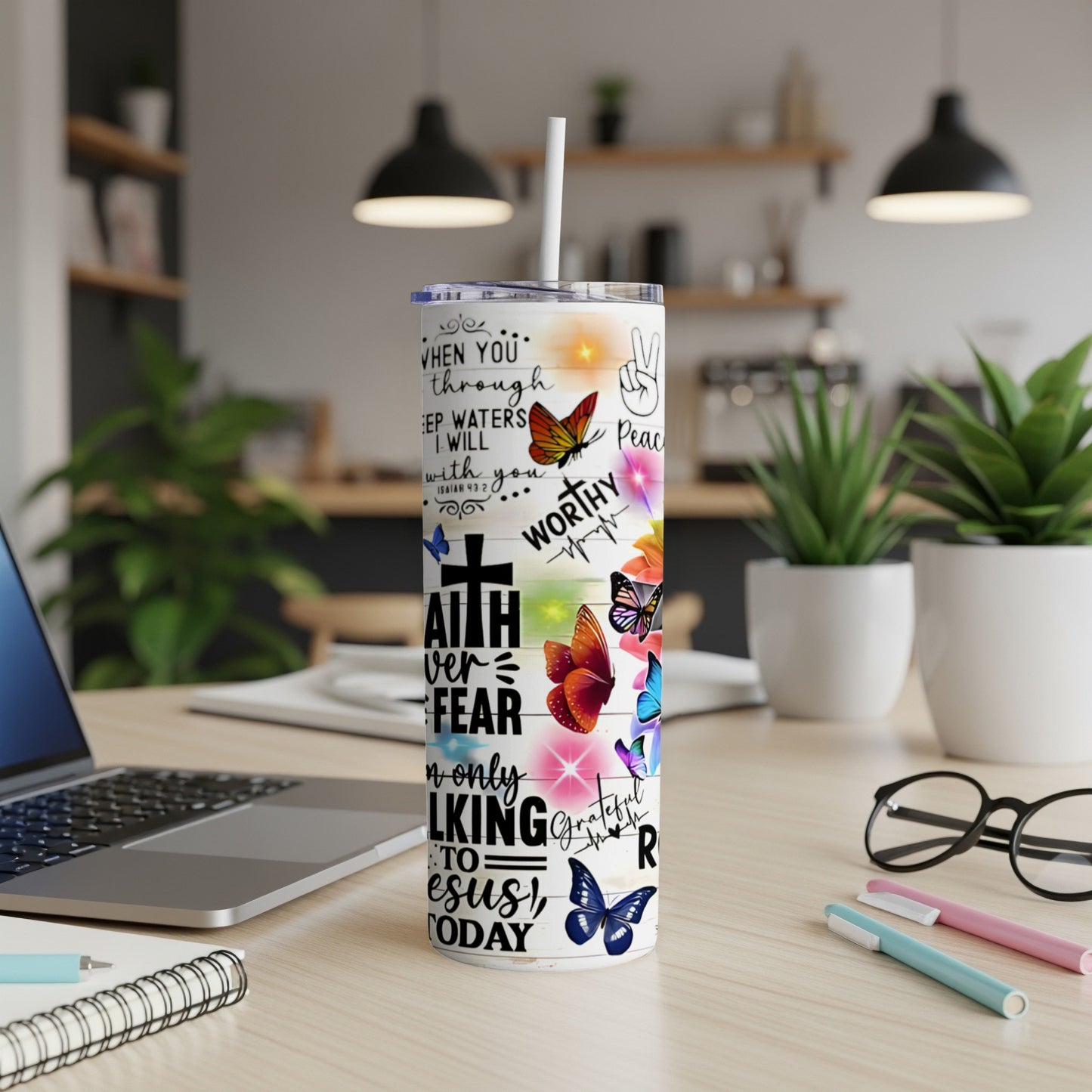 White tumbler with butterfly designs and inspirational text about faith and peace.