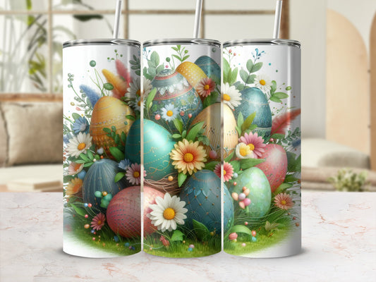 Three tumblers decorated with Easter eggs, flowers, and greenery.