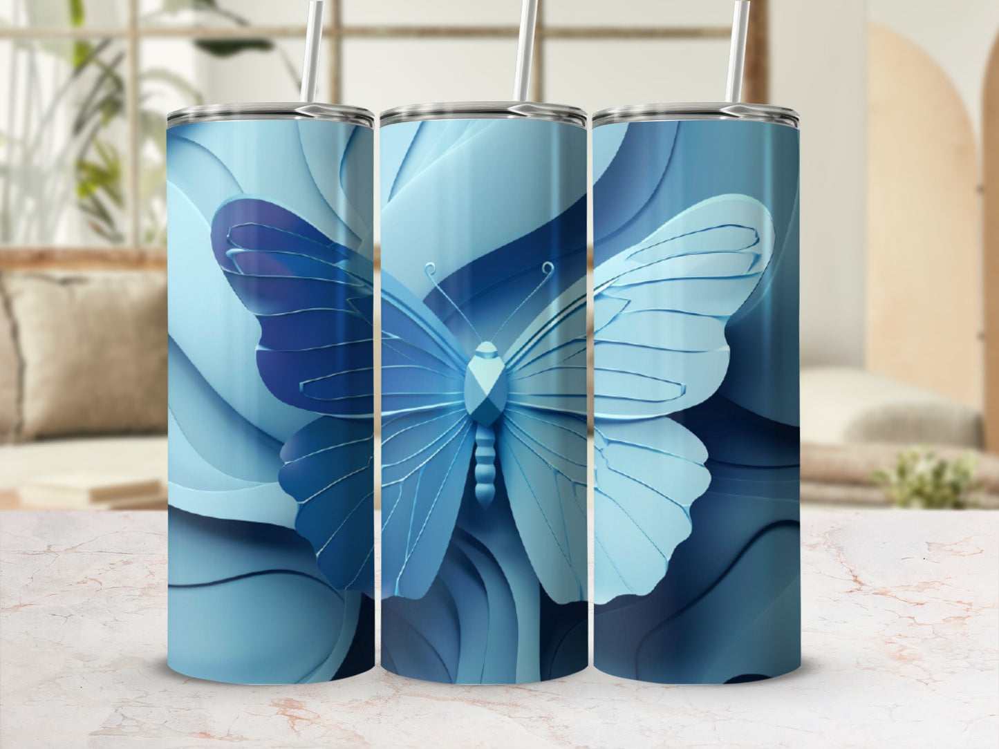 Three blue tumblers with a stylized blue butterfly design.