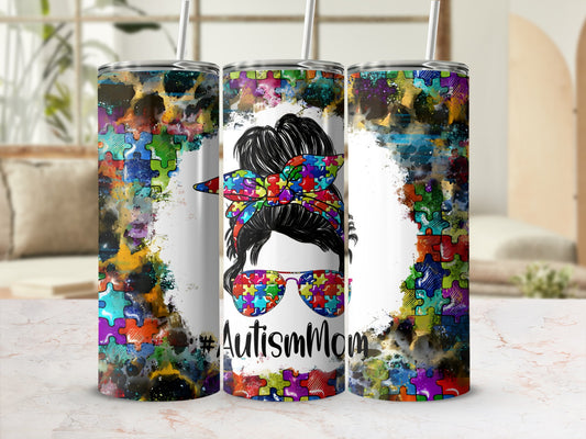 Autism Mom tumbler with colorful puzzle pieces and messy bun woman graphic.