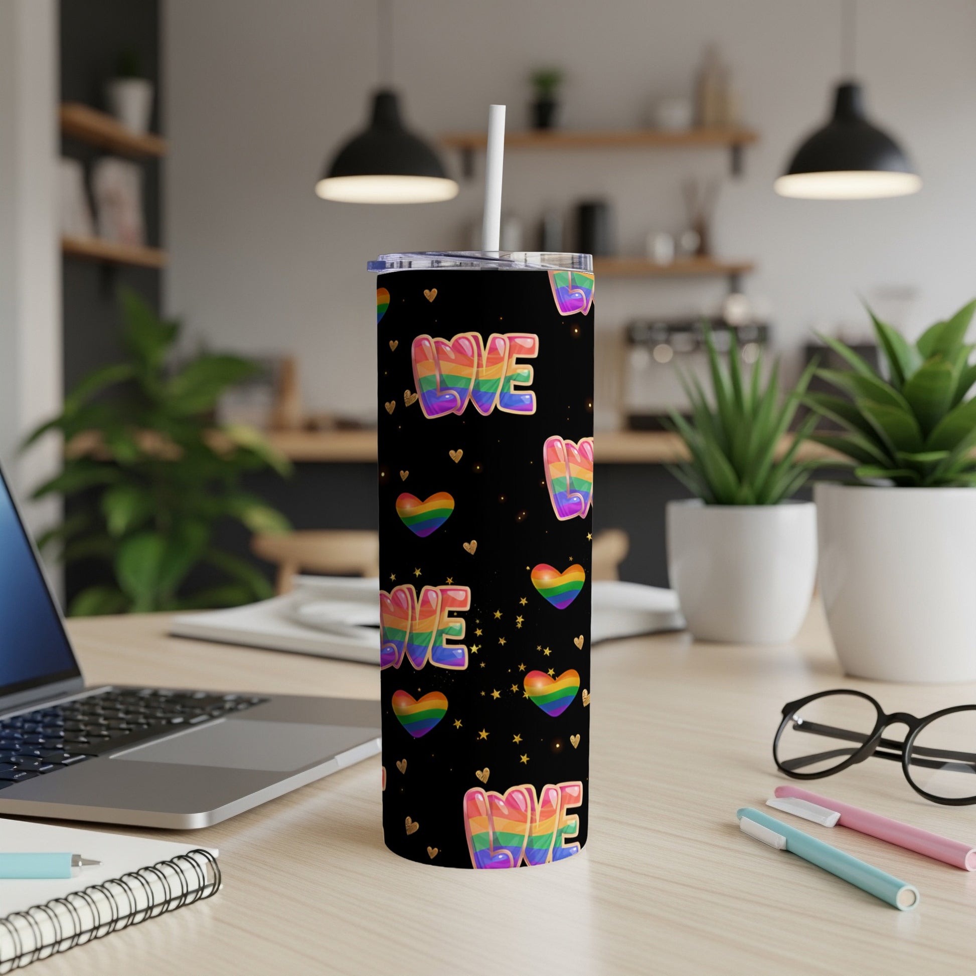 Black tumbler with "Love" in rainbow letters and rainbow hearts.