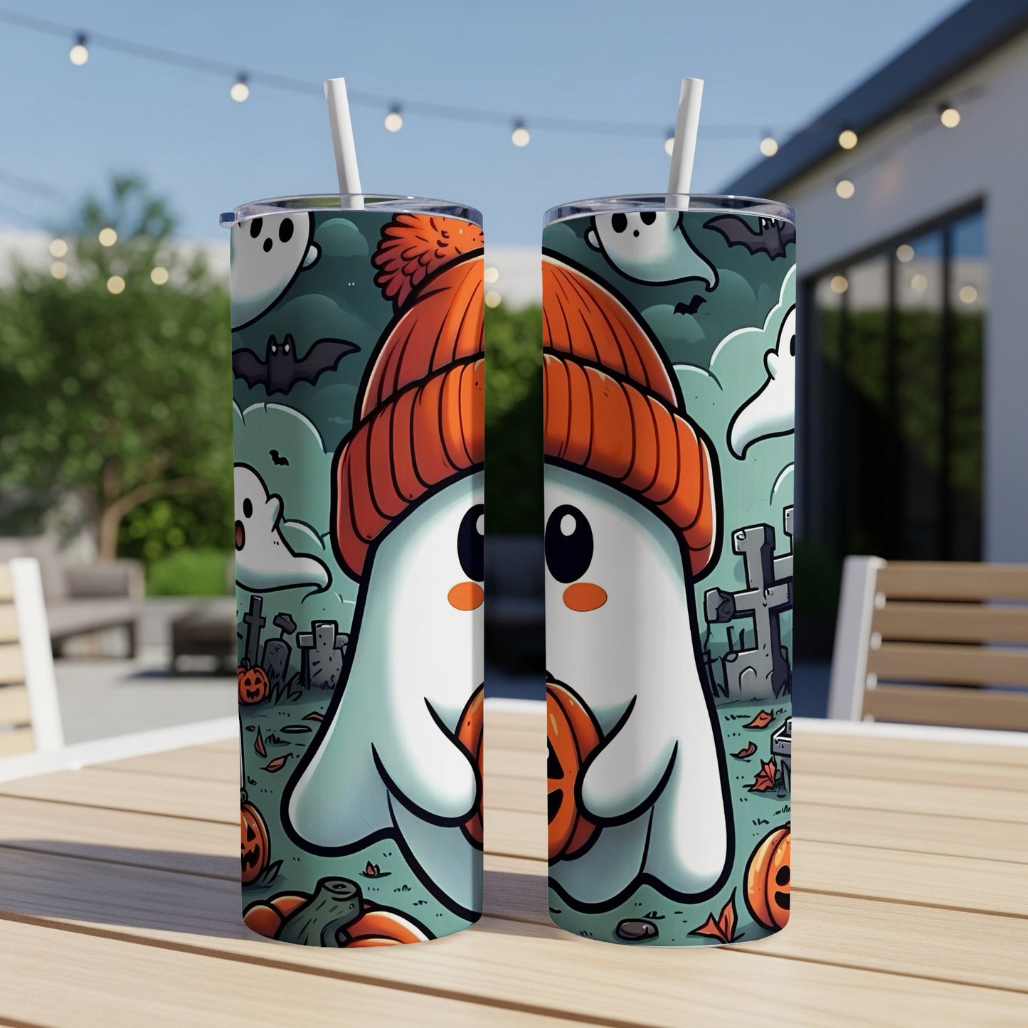 Tumbler with cartoon ghost in orange hat holding pumpkin, surrounded by bats and tombstones.