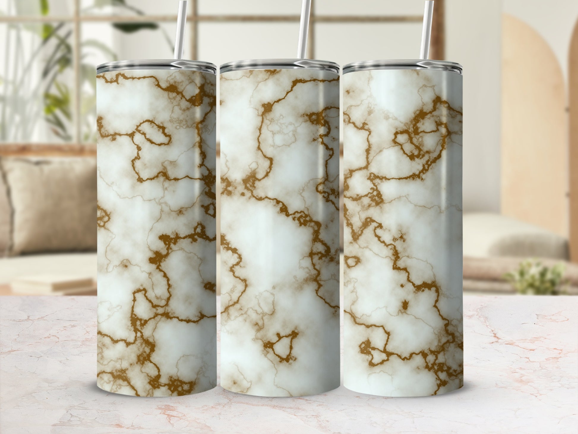 Three tumblers with a white and gold marble pattern and straws.