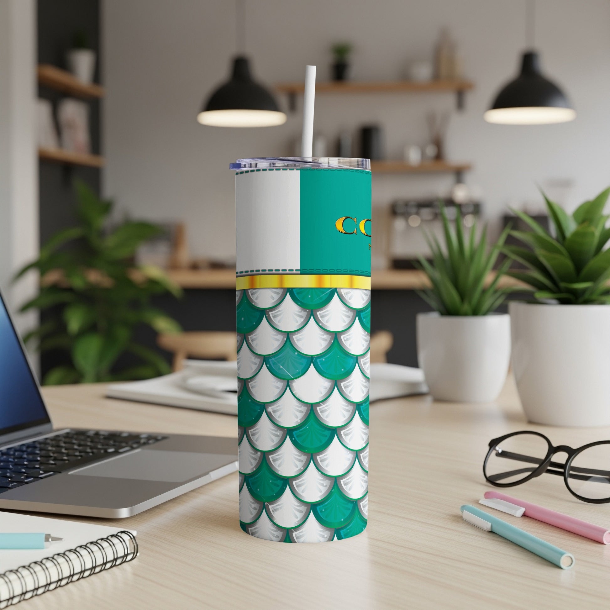Tumbler with teal, white, and gold mermaid scale pattern and a white straw.