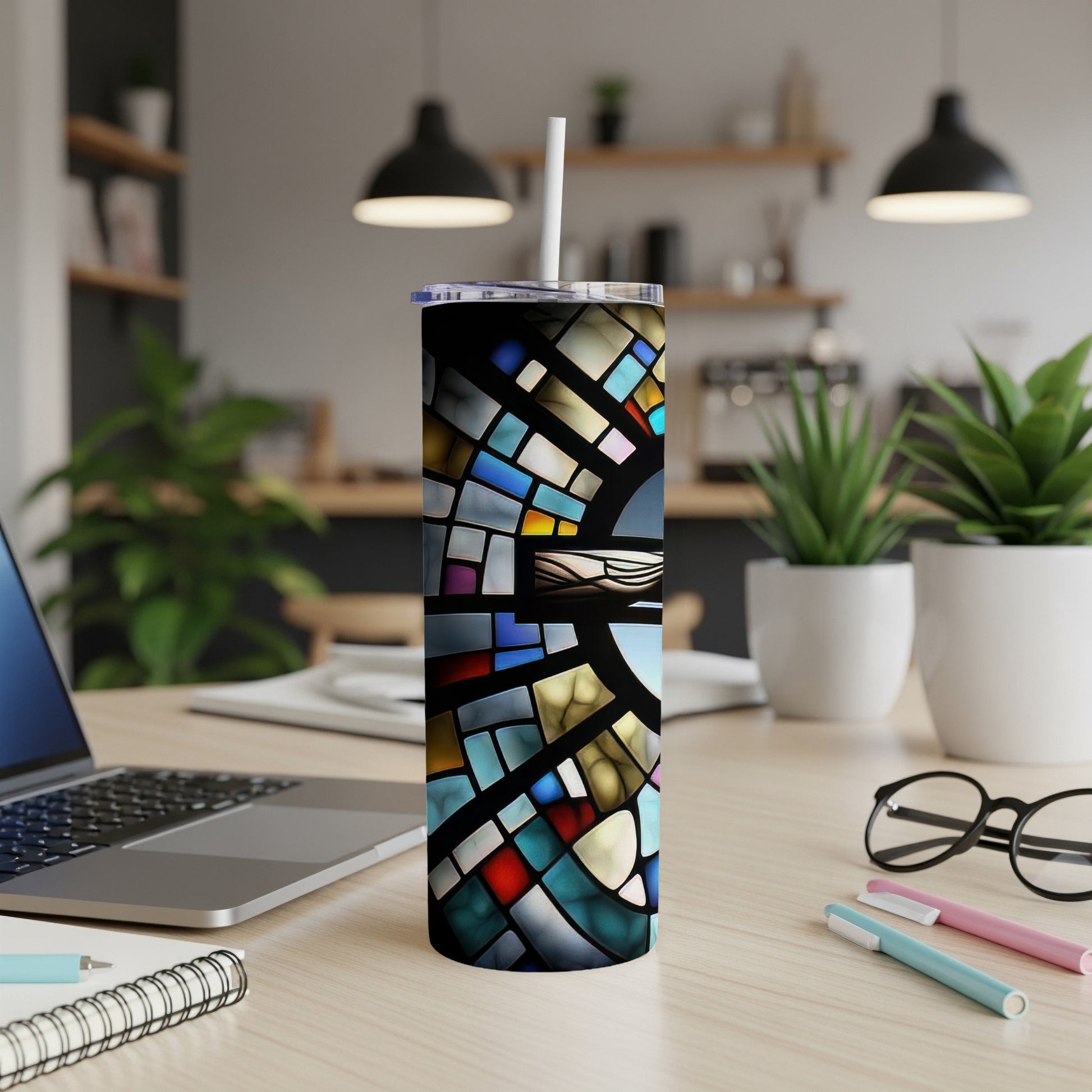Stained glass pattern tumbler with straw on a desk.