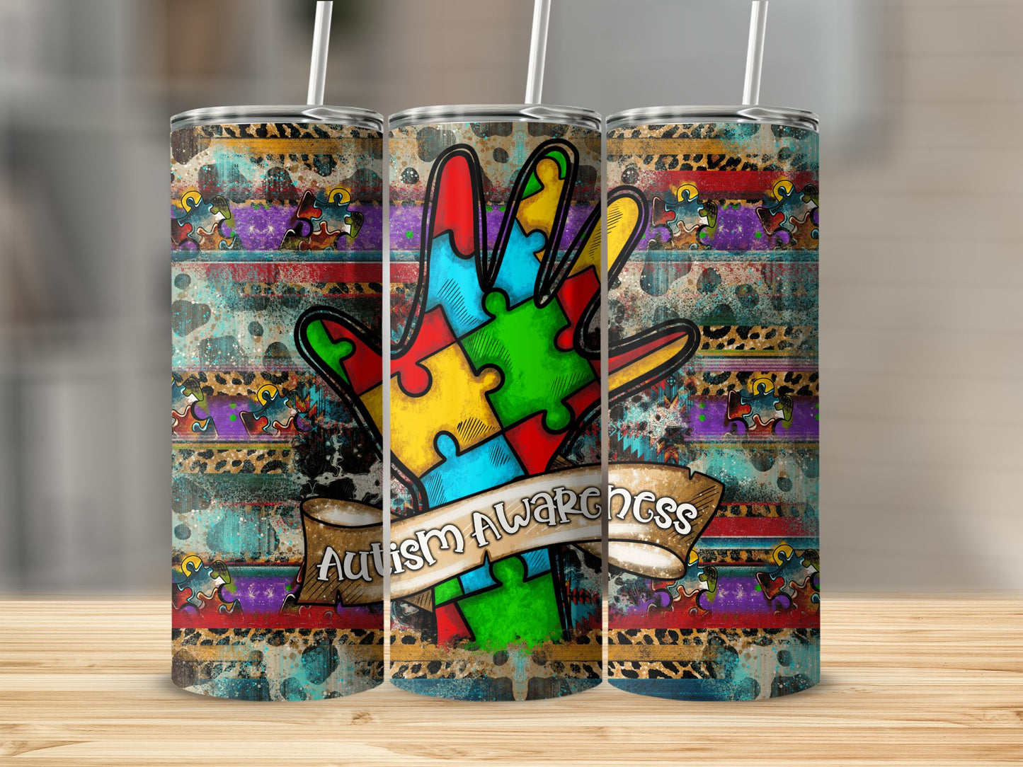 Tumbler with a colorful hand made of puzzle pieces and "Autism Awareness" ribbon.
