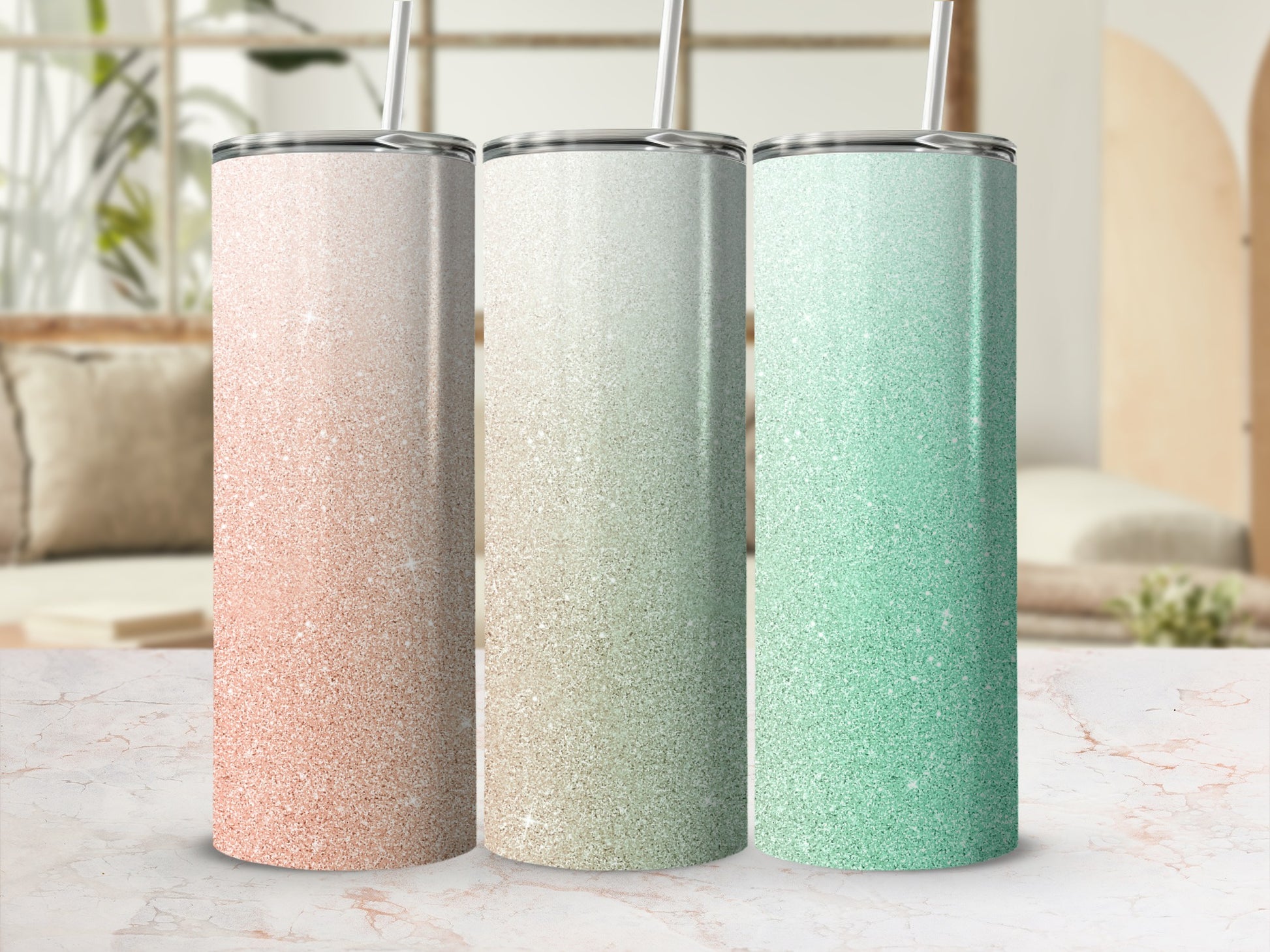 Three glitter tumblers in peach, gold, and mint green.