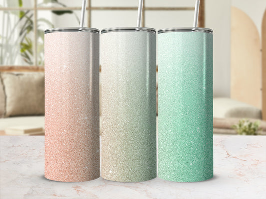 Three glitter tumblers in peach, gold, and mint green.