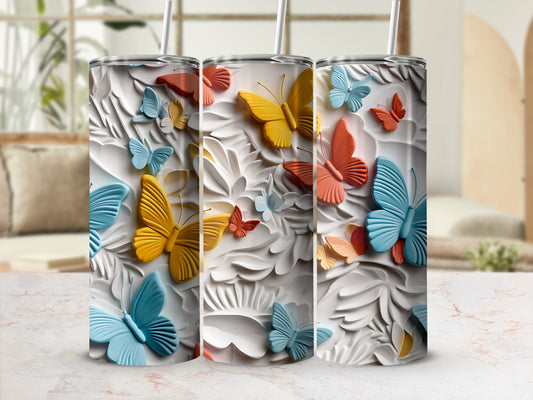 Three tumblers with 3D butterfly designs in blue, yellow, and coral.