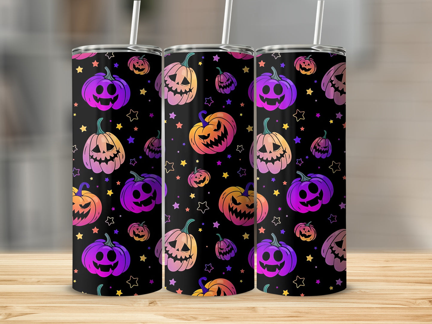 Three tumblers with a black background, featuring colorful Halloween pumpkins and stars.