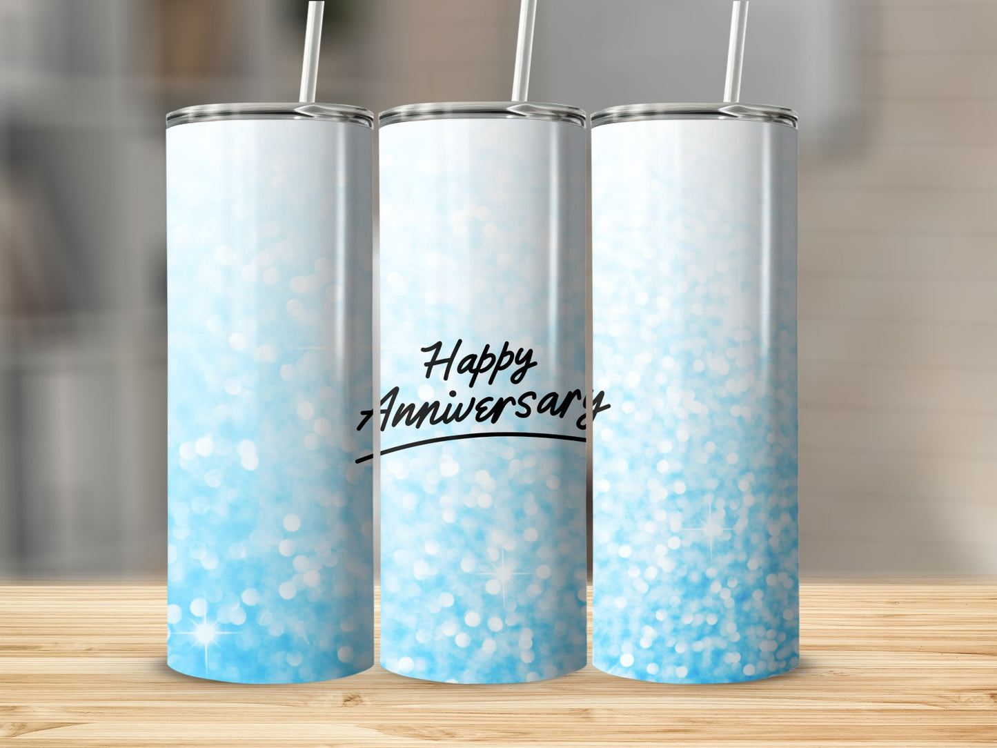Three glitter tumblers with "Happy Anniversary" text on the middle one.