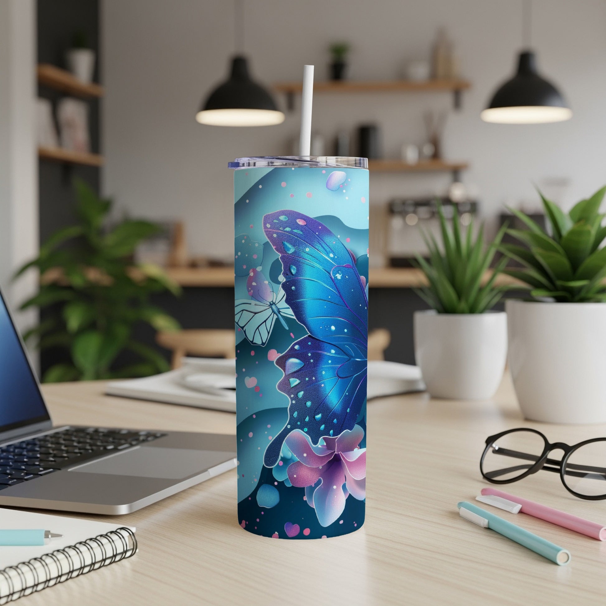 Blue butterfly and floral design on a skinny tumbler with straw.