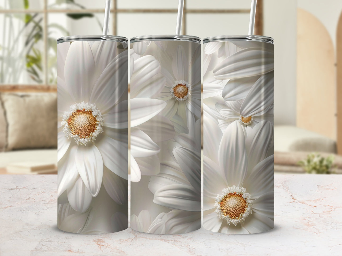 White daisy flowers wrap around three white tumblers with straws.