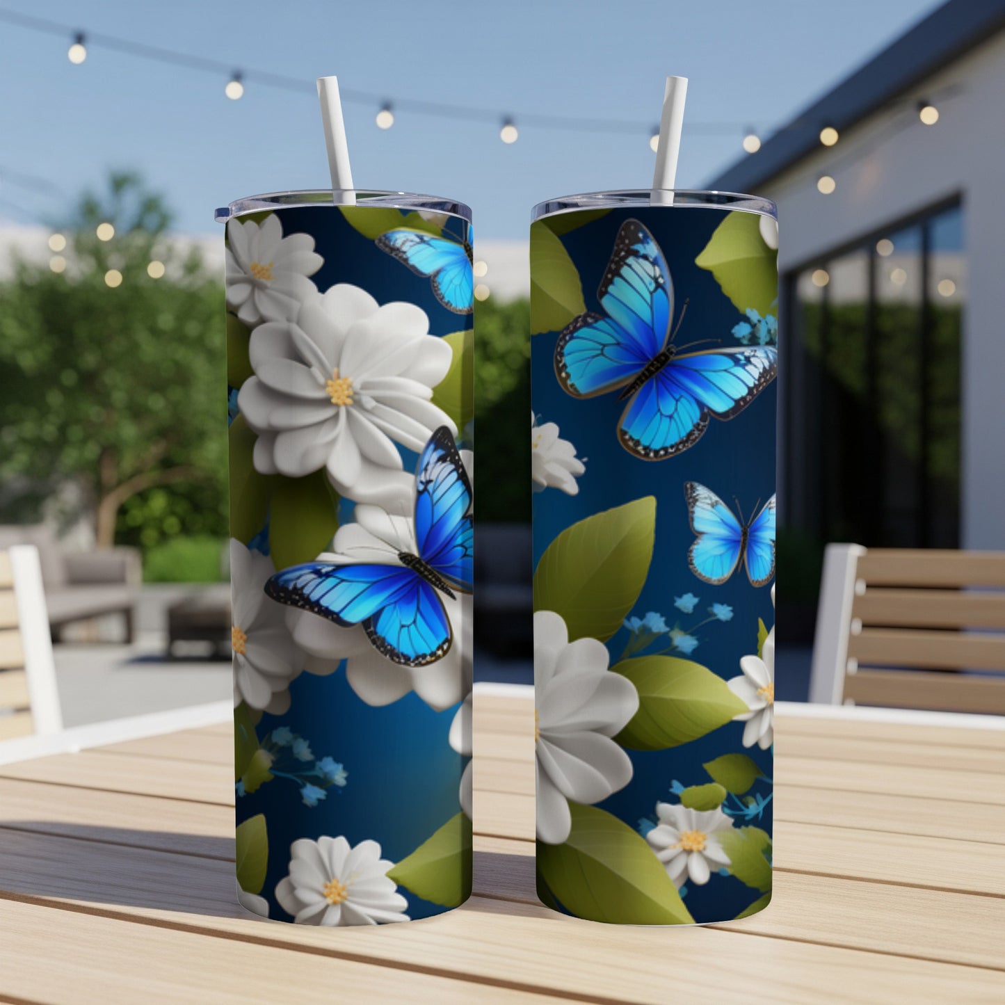 Two tumblers featuring blue butterflies and white flowers on a dark background.