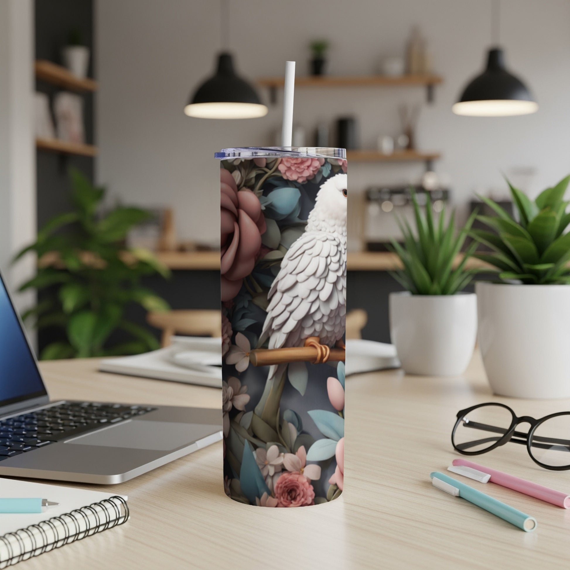 White parrot perched on a branch with floral background on a tumbler.