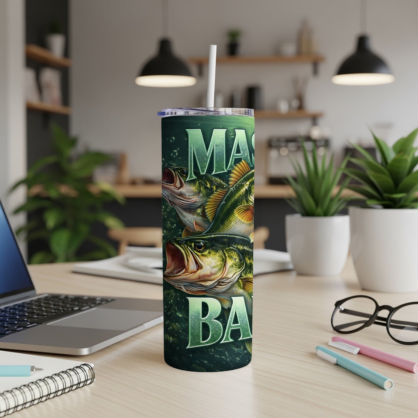 Green tumbler with "BIG BASS" text and fish graphics on a desk.