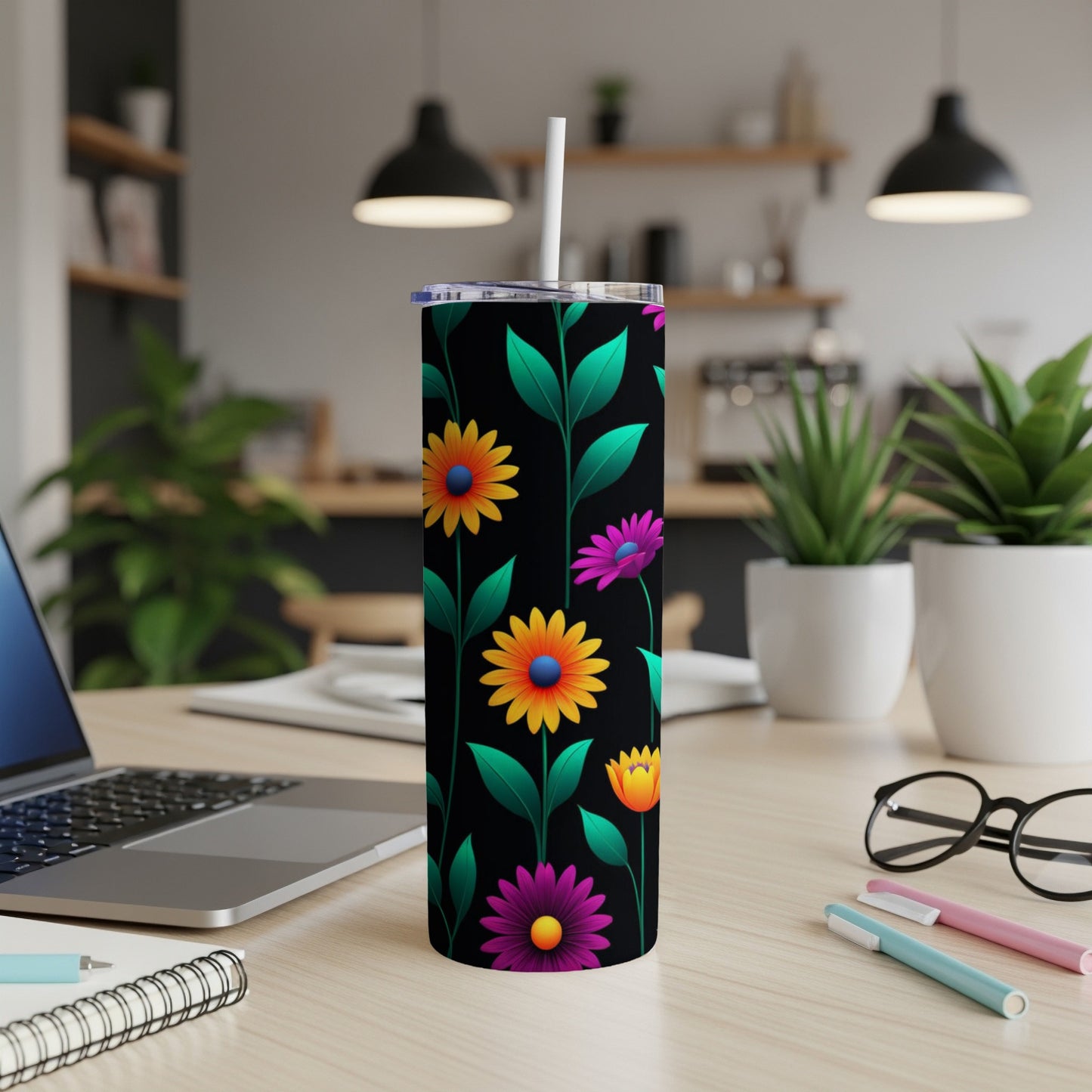 Black tumbler with colorful floral pattern and white straw.
