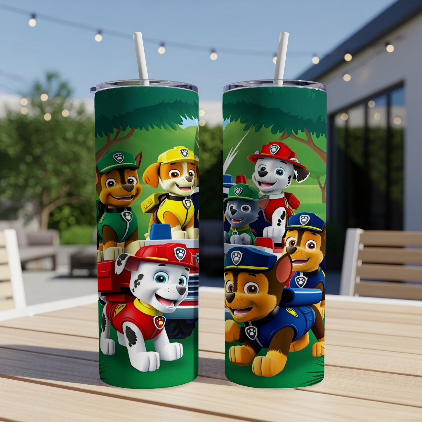 Two Paw Patrol tumblers with characters on a table outdoors.