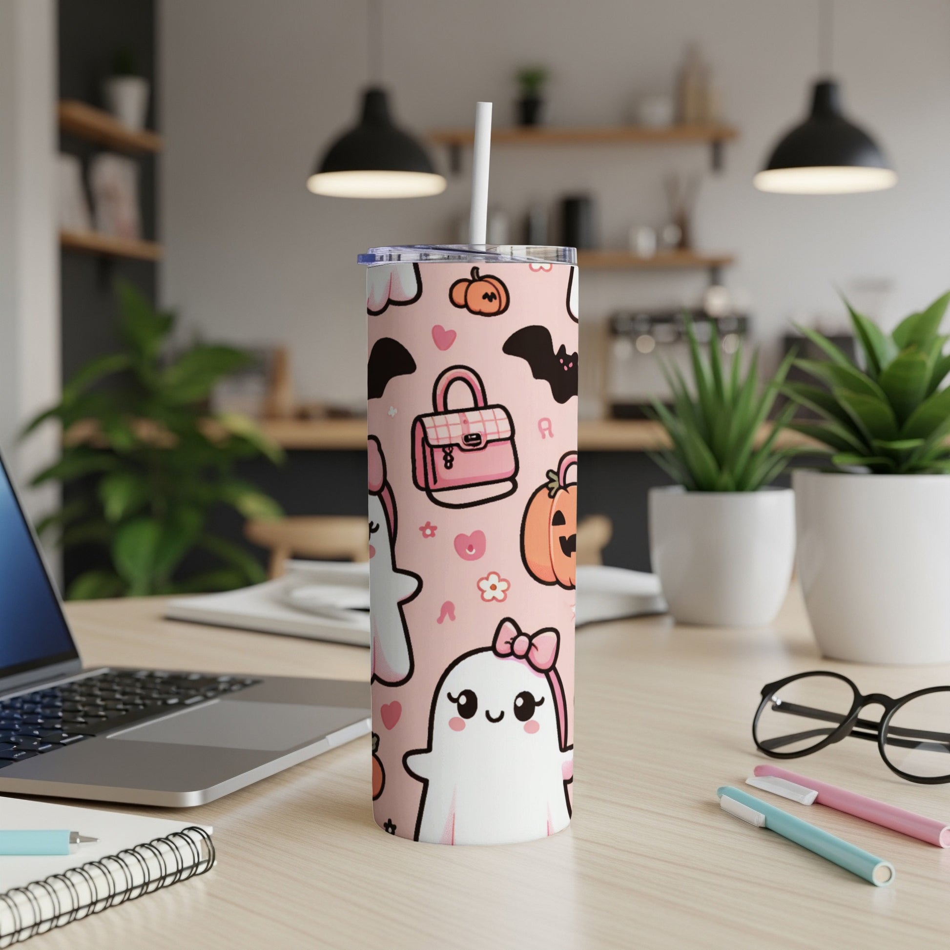 Pink tumbler with kawaii ghosts, bats, and pumpkins pattern.