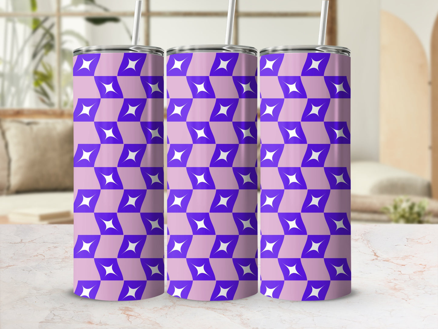 Purple and white geometric pattern on three stainless steel tumblers.