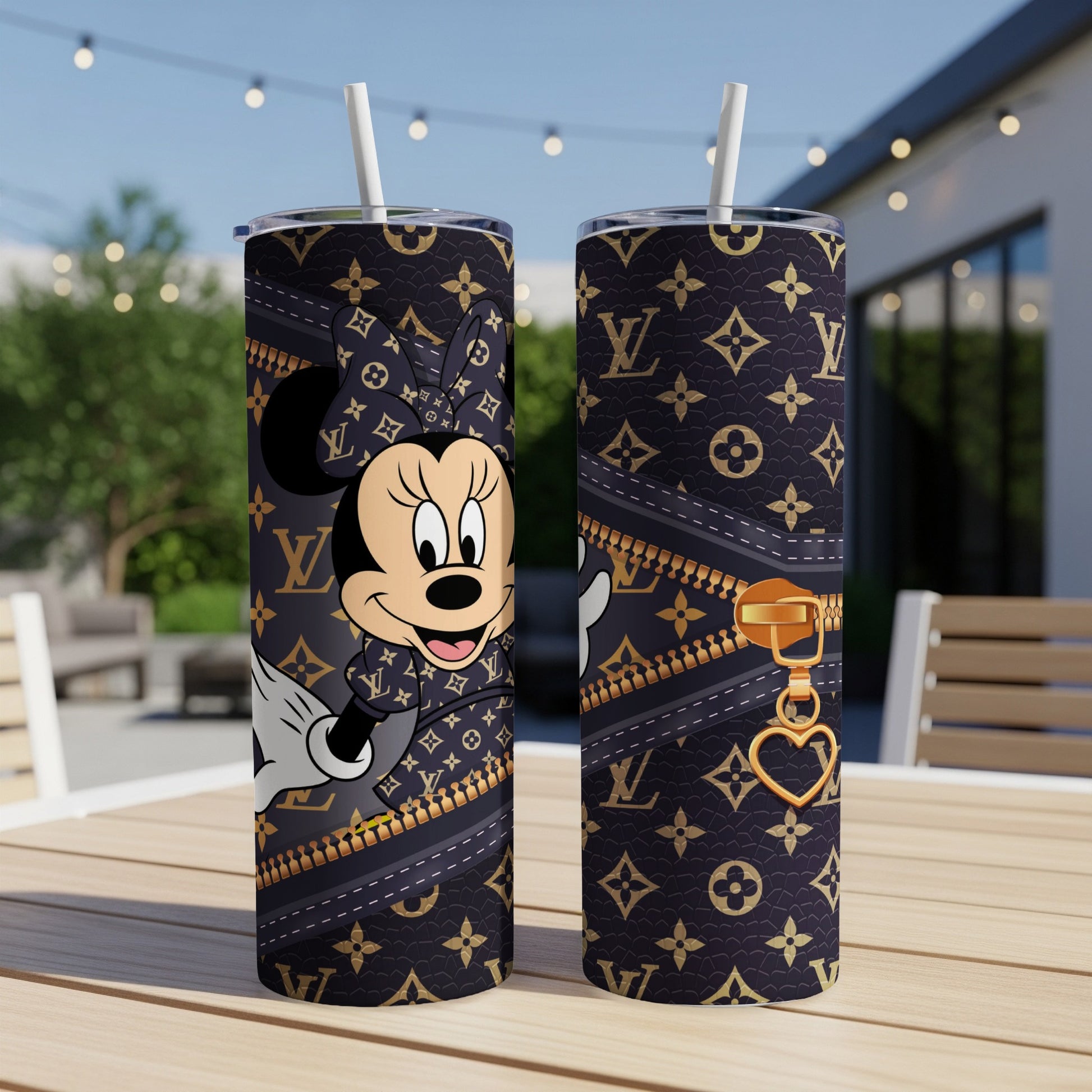 Minnie Mouse design on a dark tumbler with a gold zipper and heart charm.